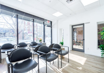 glass-wall-and-door-behind-chairs-inside-integrated-internal-medicine-patient-waiting-area