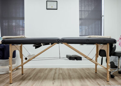 physiotherapy-bed-with-folded-blanket-medical-certificate-hanging-wall-integrated-internal-medicine-clinic-queens-ny